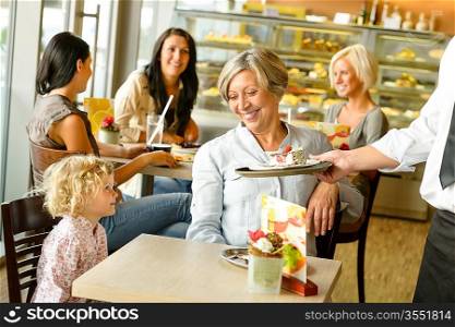 Grandmother and grandchild waiting cake order cafe dessert waiter plate