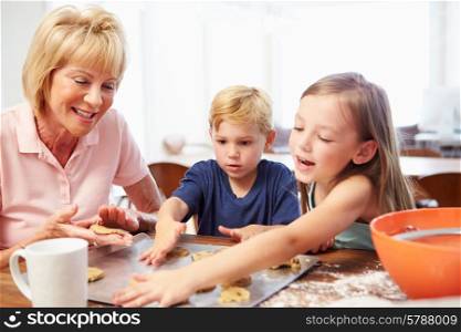 Grandmother And Grandchildren Baking Cookies Together