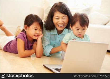 Grandmother And Grandchildren Using Laptop Together