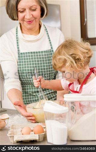 Grandmother and granddaughter baking cookies prepare dough