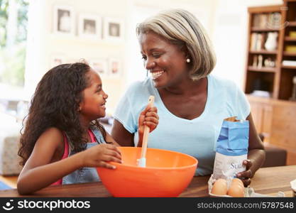 Grandmother And Granddaughter Baking Together At Home