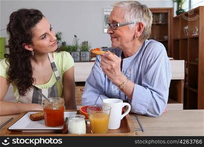 Grandmother and granddaughter having breakfast