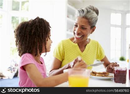 Grandmother And Granddaughter Having Breakfast Together