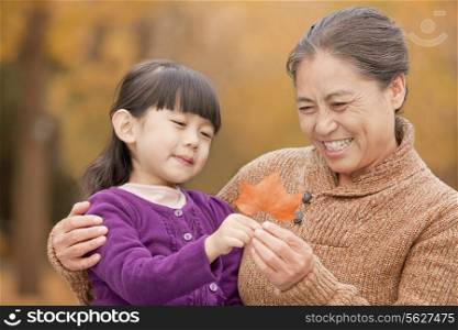 Grandmother and granddaughter in park