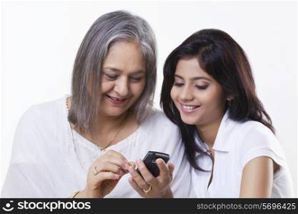 Grandmother and granddaughter looking at phone