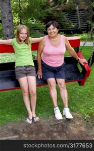 Grandmother and granddaughter on swings
