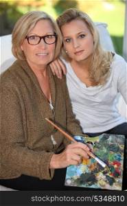 Grandmother and granddaughter painting