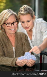 Grandmother and granddaughter playing cards