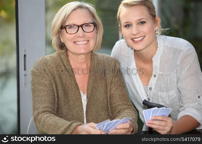grandmother and granddaughter playing cards