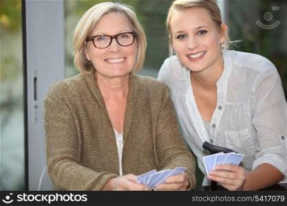 grandmother and granddaughter playing cards