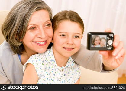 Grandmother and granddaughter take picture themselves smiling close-up portrait