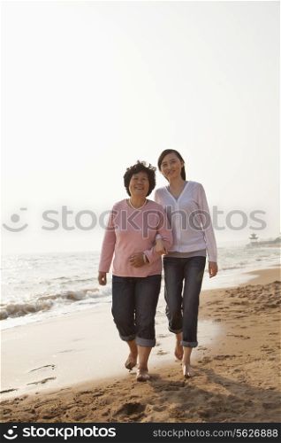Grandmother and Granddaughter Taking a Walk by the Beach