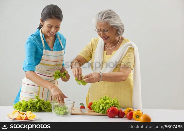 Grandmother and granddaughter working in the kitchen