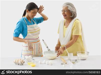 Grandmother and granddaughter working in the kitchen