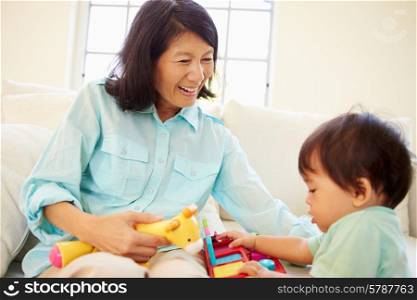 Grandmother And Grandson Playing With Toy Together