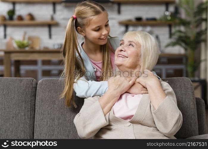 grandmother granddaughter looking each other medium shot