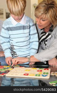 Grandmother helping her grandson with a puzzle