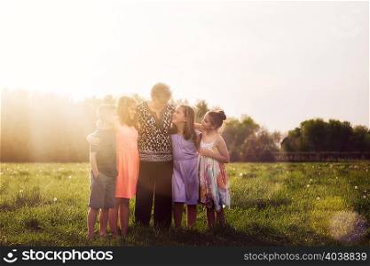 Grandmother in field with grandchildren