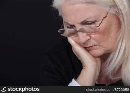 grandmother looking concerned against black background