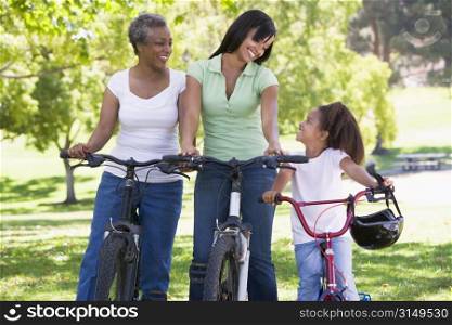 Grandmother mother and granddaughter bike riding.