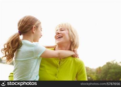 Grandmother Playing With Granddaughter Outdoors