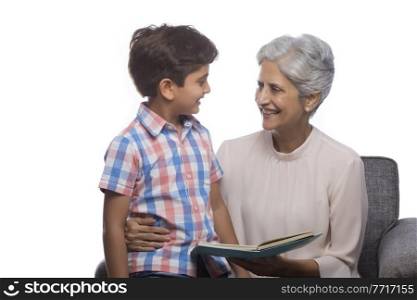 Grandmother reading book to her grandson