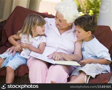 Grandmother reading to grandchildren.