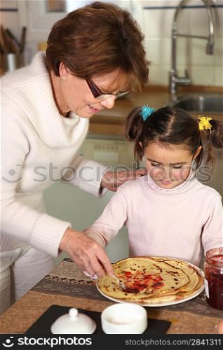 Grandmother serving pancakes