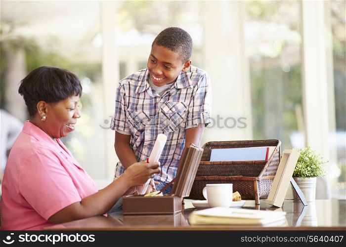Grandmother Showing Document To Grandson