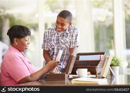 Grandmother Showing Document To Grandson