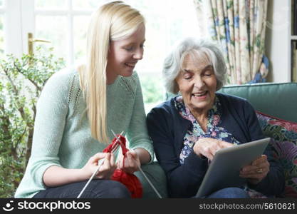 Grandmother Using Digital Tablet Asd Granddaughter Knits