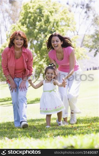 Grandmother with adult daughter and granddaughter in park