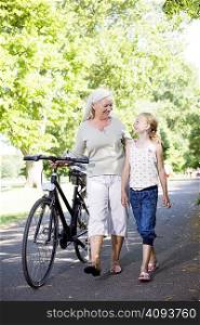 Grandmother with granddaughter and bike
