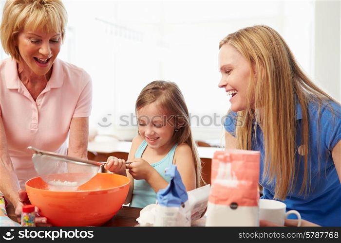 Grandmother With Granddaughter And Mother Baking Together