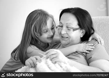 Grandmother with granddaughter Learning to knit