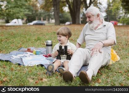 grandpa grandson picnic with binocular