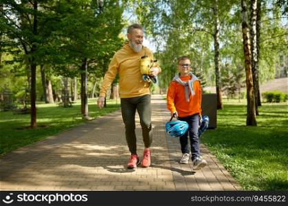 Grandpa with grandson walking in park preparing roller-skates and helmet or extreme racing. Grandpa with grandson walking in park preparing get ready to roller-skate