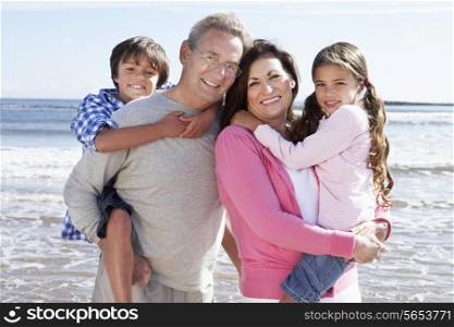 Grandparents And Grandchildren Having Fun On Beach Holiday