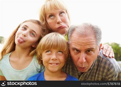 Grandparents And Grandchildren Pulling Funny Faces