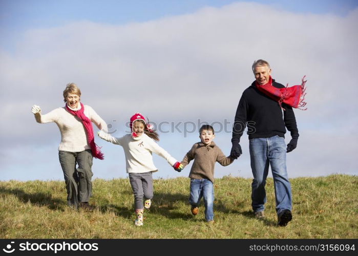 Grandparents And Grandchildren Running In The Park