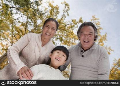 Grandparents and granddaughter in park