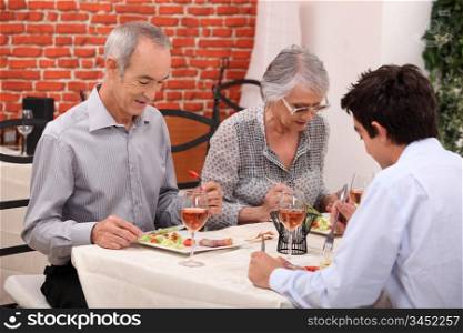 Grandparents and grandson at restaurant