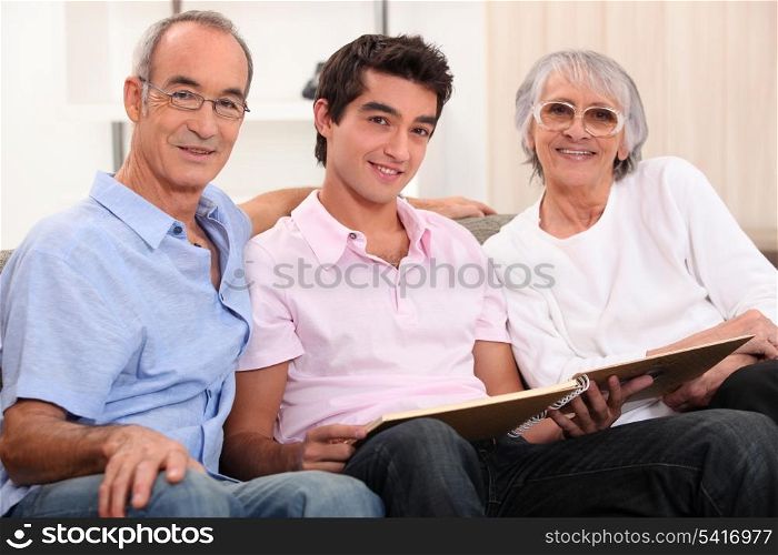 grandparents and grandson skimming through album