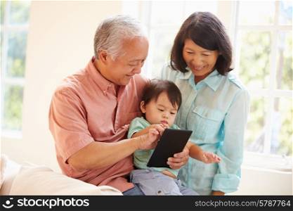 Grandparents And Grandson Using Digital Tablet Together