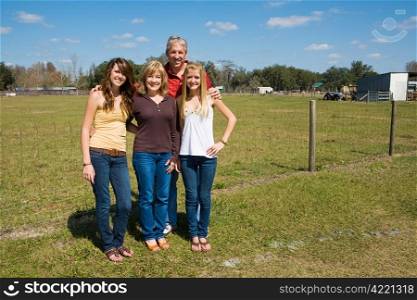 Grandparents and their beautiful granddaughters on the farm with room for text.