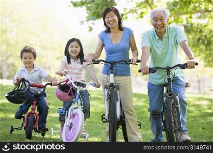 Grandparents bike riding with grandchildren.