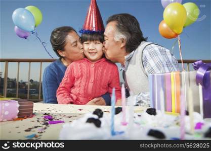 Grandparents celebrating birthday of granddaughter