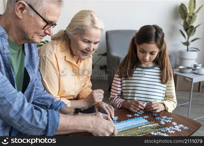 grandparents girl doing puzzle close up