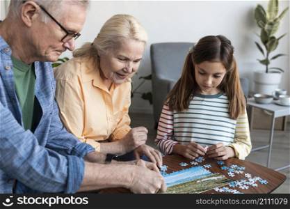 grandparents girl doing puzzle close up