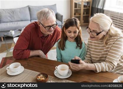 grandparents girl looking phone